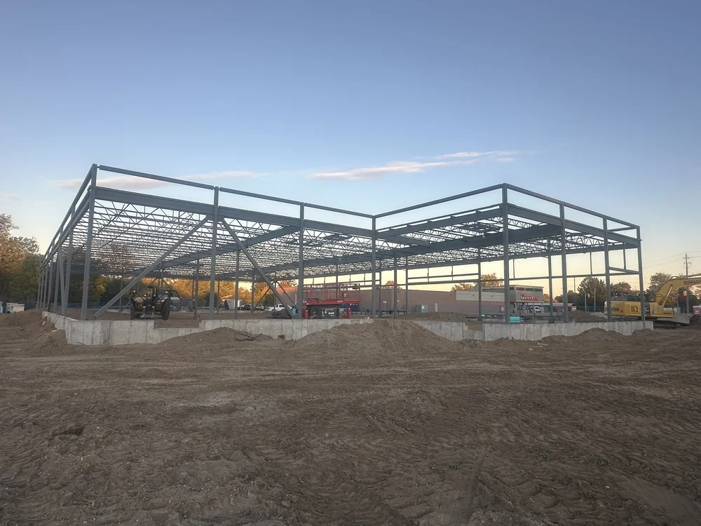 Completed steel frame with columns, beams and roof deck — Commercial Plaza